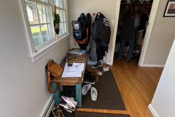 Pile of thing accumulating by the door for a family prior to the renovation