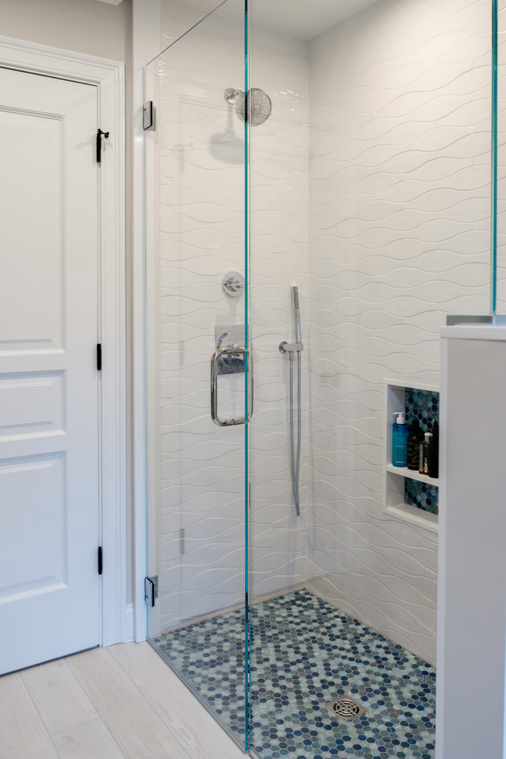 Custom tiling in a shower after a bathroom remodel by Marlene & Co