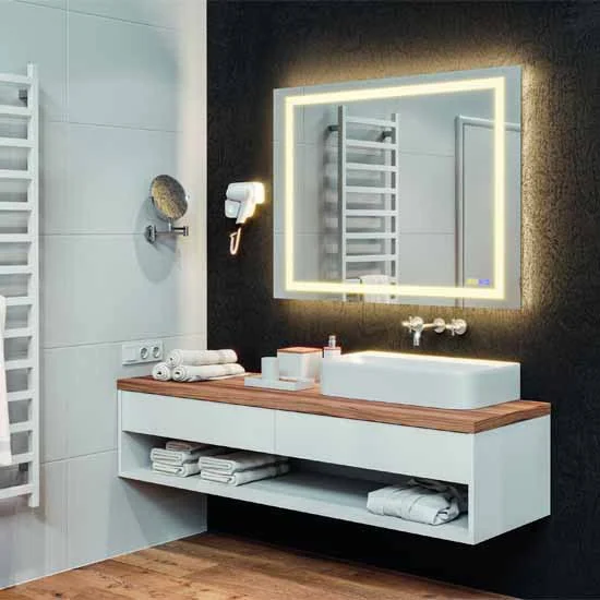 Modern bathroom remodel with a lighted mirror designed by Marlene & Co