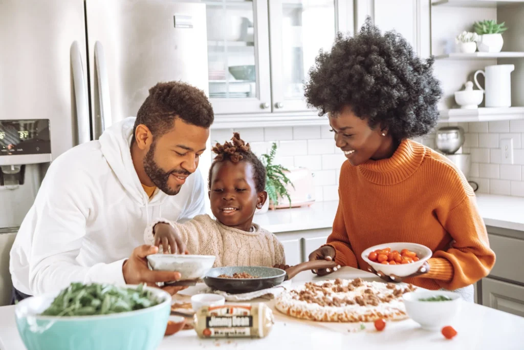 Family cooking together in a remodeled kitchen